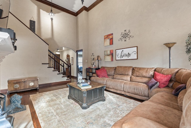 living room with a high ceiling and crown molding