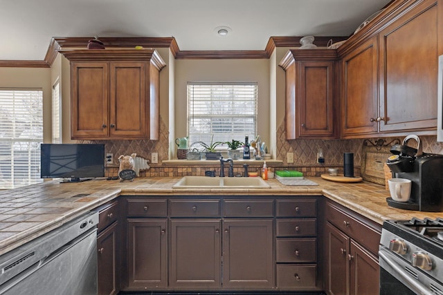 kitchen featuring sink, stainless steel gas range oven, backsplash, and dishwashing machine