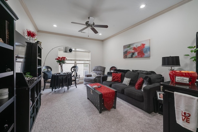 living room with carpet, ceiling fan, and ornamental molding