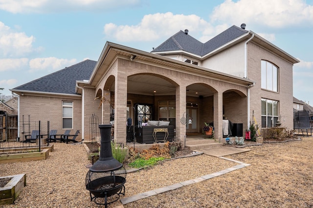 rear view of house featuring a patio area and an outdoor fire pit