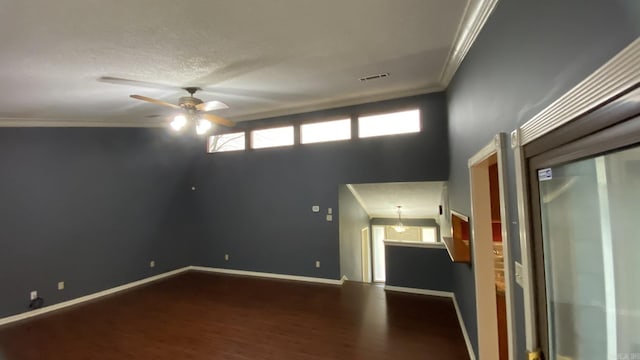 spare room with a textured ceiling, ceiling fan, ornamental molding, and wood-type flooring