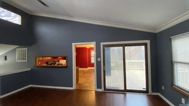 unfurnished room with hardwood / wood-style flooring, crown molding, and a wealth of natural light