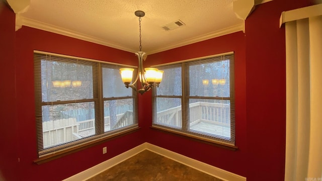 unfurnished dining area featuring an inviting chandelier, carpet floors, crown molding, and a textured ceiling