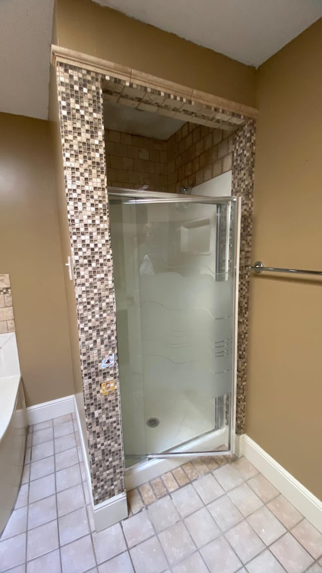 bathroom featuring independent shower and bath and tile patterned flooring