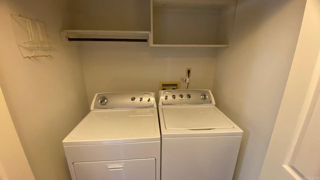 washroom featuring washer and clothes dryer