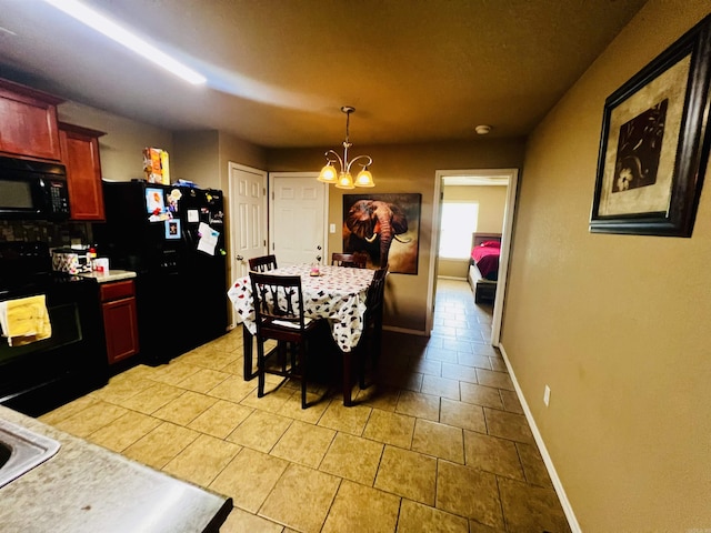 tiled dining room featuring a chandelier