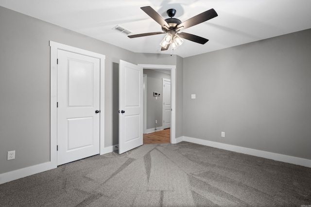 unfurnished bedroom with ceiling fan and carpet