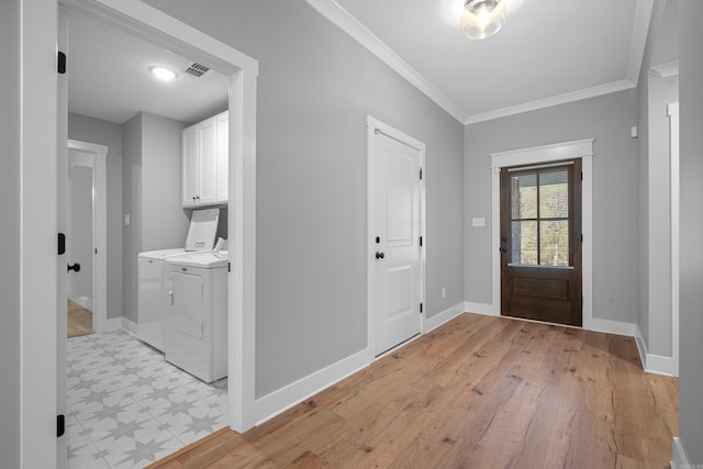 entrance foyer featuring independent washer and dryer and crown molding