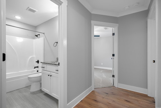 full bathroom featuring toilet, vanity, hardwood / wood-style floors, shower / bath combination, and ornamental molding