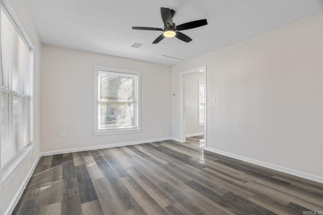 empty room with ceiling fan and dark hardwood / wood-style floors