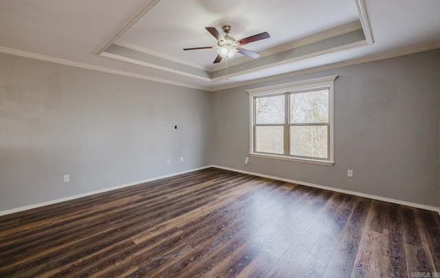 spare room featuring a raised ceiling, ceiling fan, dark hardwood / wood-style floors, and crown molding