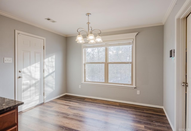 dining room featuring an inviting chandelier, ornamental molding, and dark hardwood / wood-style floors