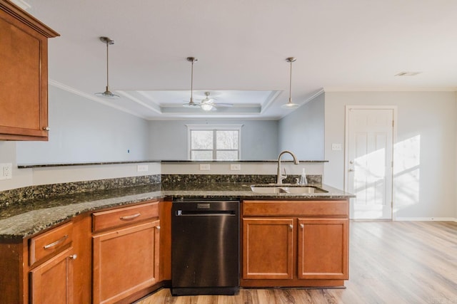 kitchen featuring ceiling fan, sink, a tray ceiling, crown molding, and hanging light fixtures