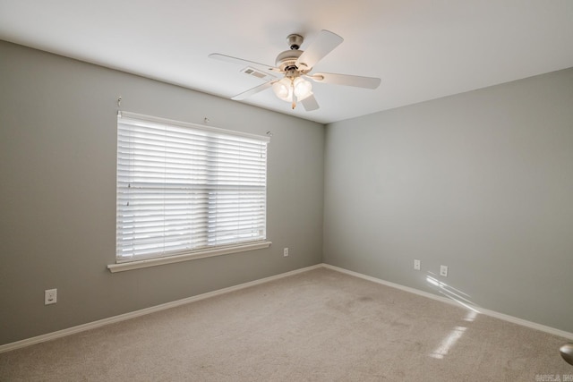 unfurnished room with ceiling fan and light colored carpet