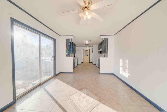 unfurnished room featuring ceiling fan and ornamental molding