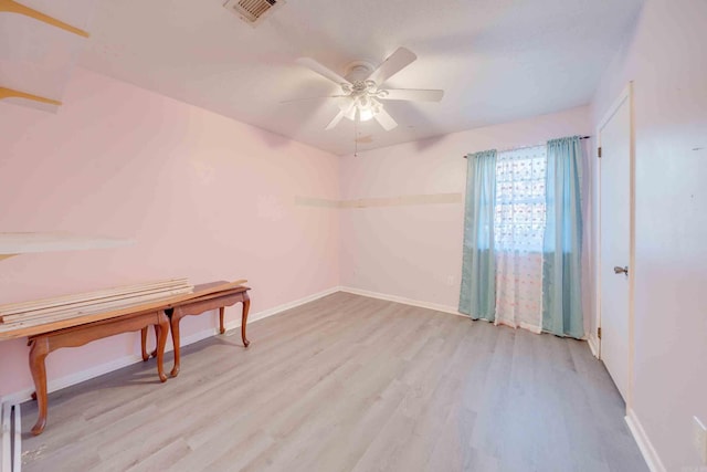 empty room featuring light wood-type flooring and ceiling fan