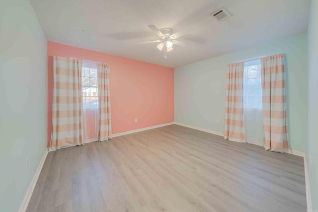 empty room with light hardwood / wood-style floors and ceiling fan