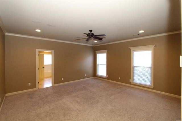 spare room featuring ceiling fan, light colored carpet, and crown molding