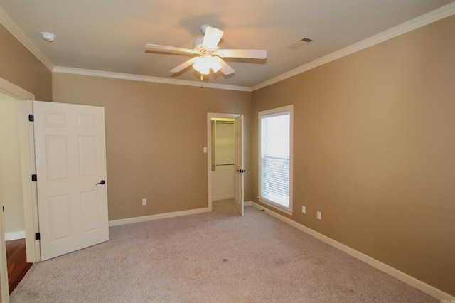 unfurnished bedroom featuring light carpet, ceiling fan, and ornamental molding