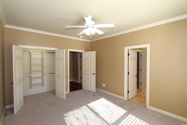 unfurnished bedroom with ceiling fan, a closet, light colored carpet, and crown molding