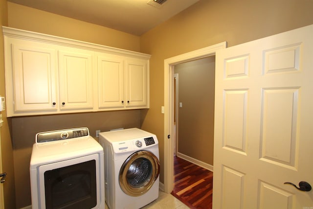 washroom featuring cabinets and separate washer and dryer