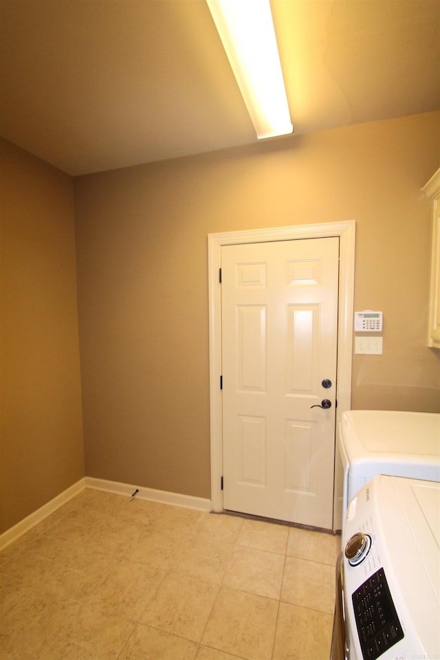 washroom featuring washer and dryer and light tile patterned flooring