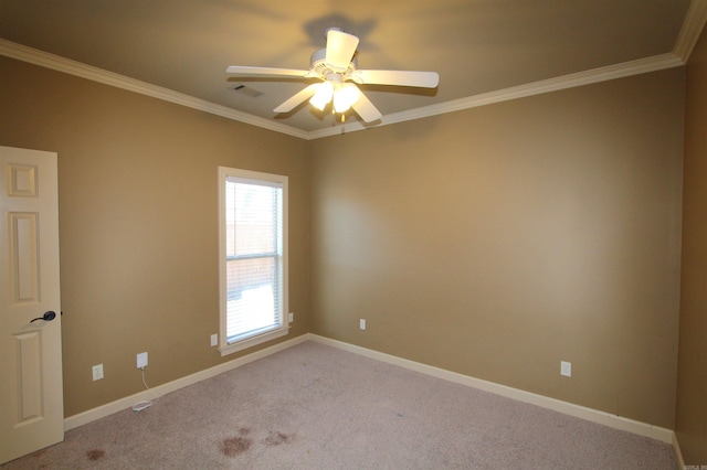 carpeted empty room with ceiling fan and crown molding