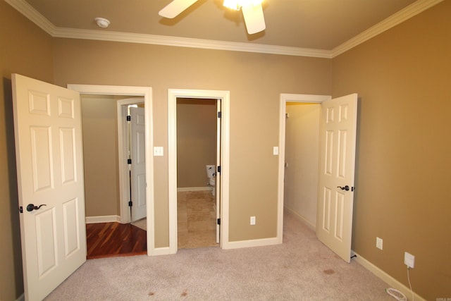 unfurnished bedroom featuring ceiling fan, light colored carpet, and crown molding