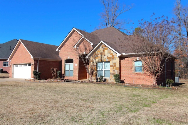 view of front of house with a front lawn and a garage