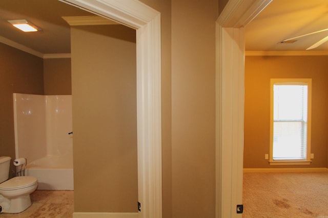 bathroom featuring plenty of natural light, toilet, and ornamental molding