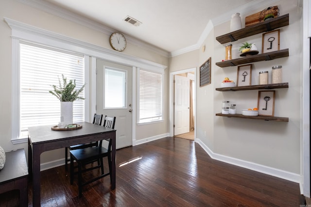 dining space with plenty of natural light, dark hardwood / wood-style floors, and crown molding