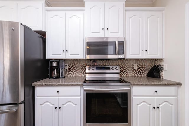 kitchen featuring appliances with stainless steel finishes, decorative backsplash, and white cabinets