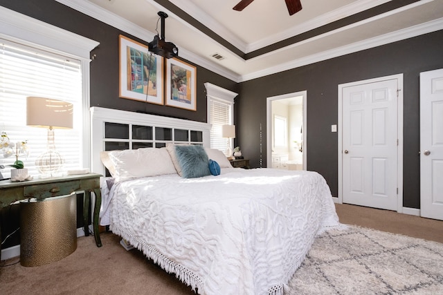 carpeted bedroom featuring ceiling fan, ensuite bathroom, and ornamental molding