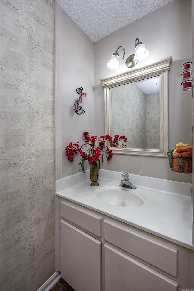 bathroom with a textured ceiling and vanity