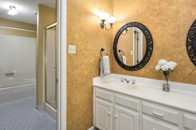 bathroom featuring a shower with shower door, a textured ceiling, tile patterned floors, and vanity