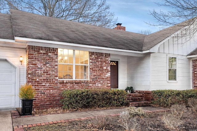 view of exterior entry with a garage