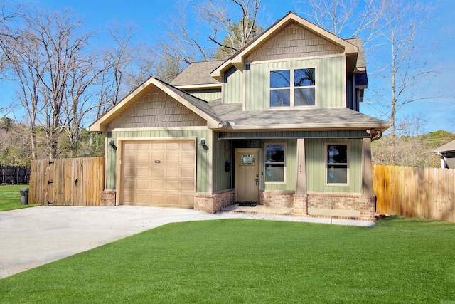 view of front of property with an attached garage, fence, a front lawn, and board and batten siding