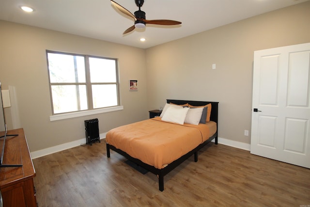 bedroom featuring ceiling fan and dark wood-type flooring