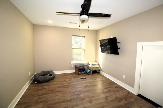 misc room with ceiling fan and dark hardwood / wood-style floors