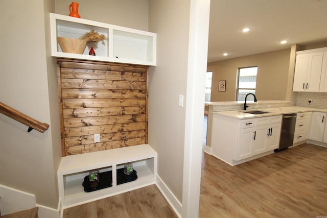 mudroom with sink and light hardwood / wood-style flooring