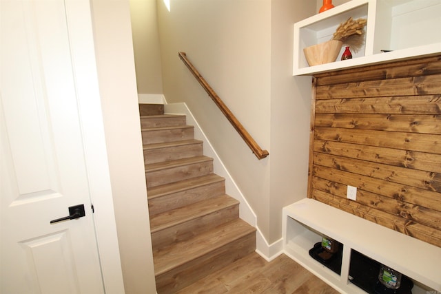 mudroom featuring wood walls and hardwood / wood-style floors