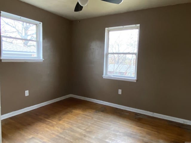 spare room with ceiling fan and wood-type flooring