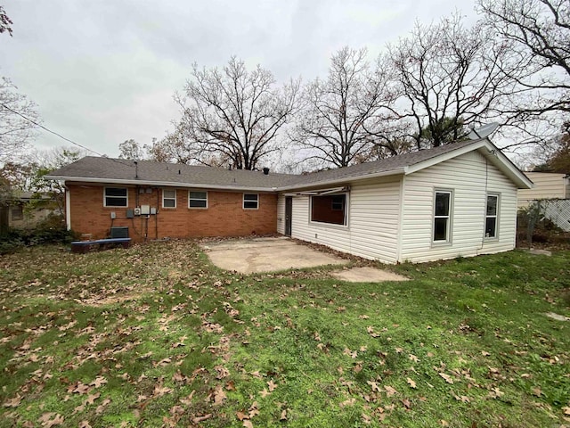 rear view of house with a patio area and a yard