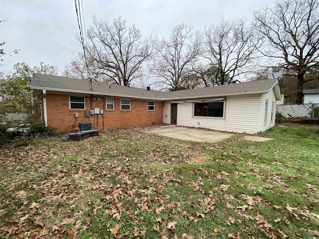 rear view of property featuring a yard and a patio