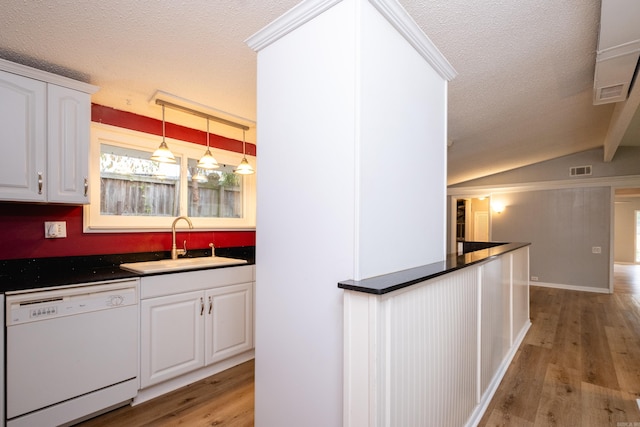 kitchen with lofted ceiling, white cabinetry, sink, white dishwasher, and light hardwood / wood-style flooring