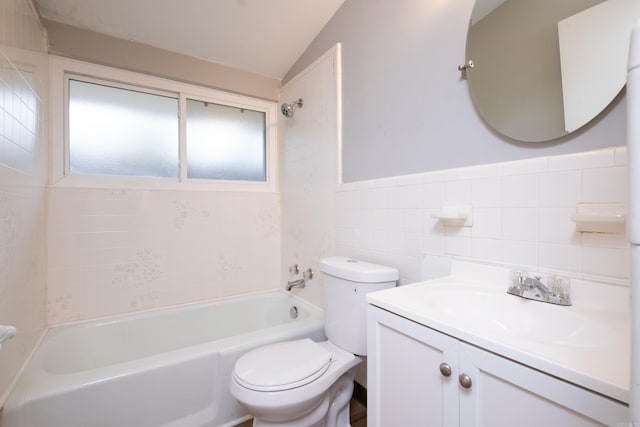 full bathroom with toilet, vanity, tile walls, lofted ceiling, and tiled shower / bath combo