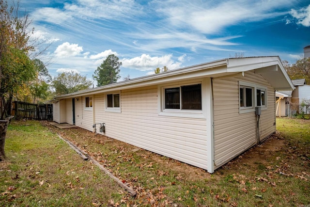 view of side of home with a yard