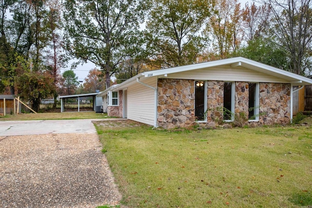 ranch-style house with a front lawn and a carport