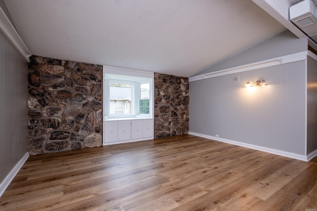 unfurnished living room with lofted ceiling and hardwood / wood-style flooring