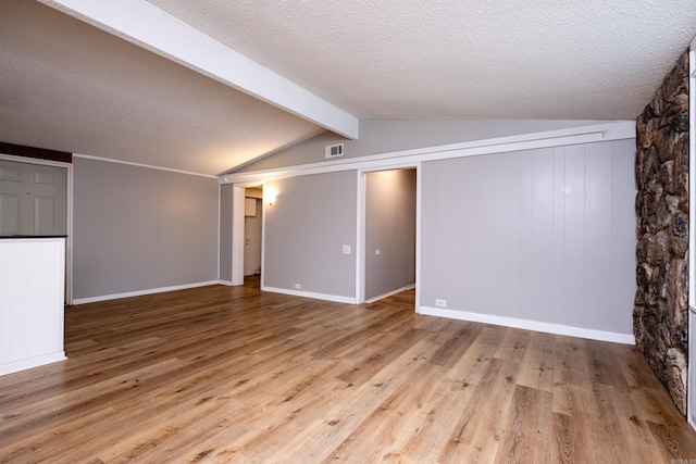 interior space with light wood-type flooring and a textured ceiling